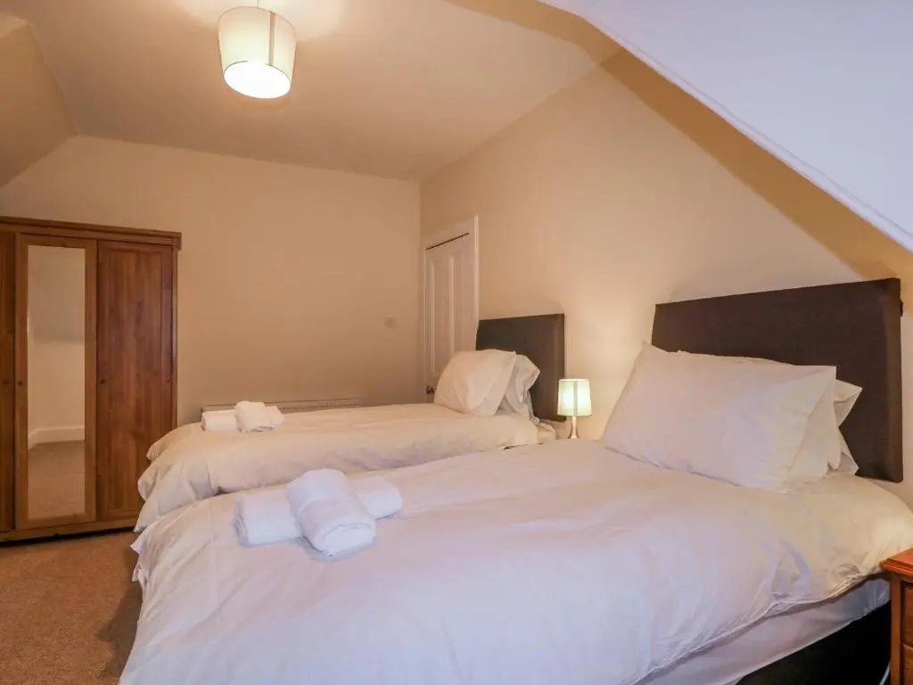 two beds sitting next to each other in a bedroom at Kinnaird House in Grantown on Spey
