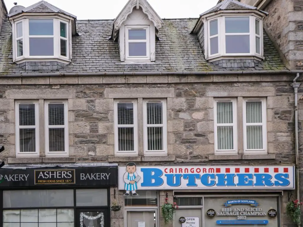 an old building with a sign in front of it at Kinnaird House in Grantown on Spey