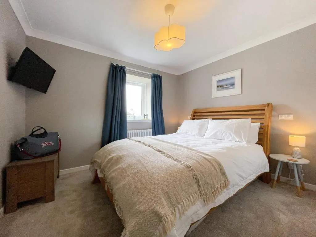 a bedroom with a large bed and a window at The Grain Store in Aberarder