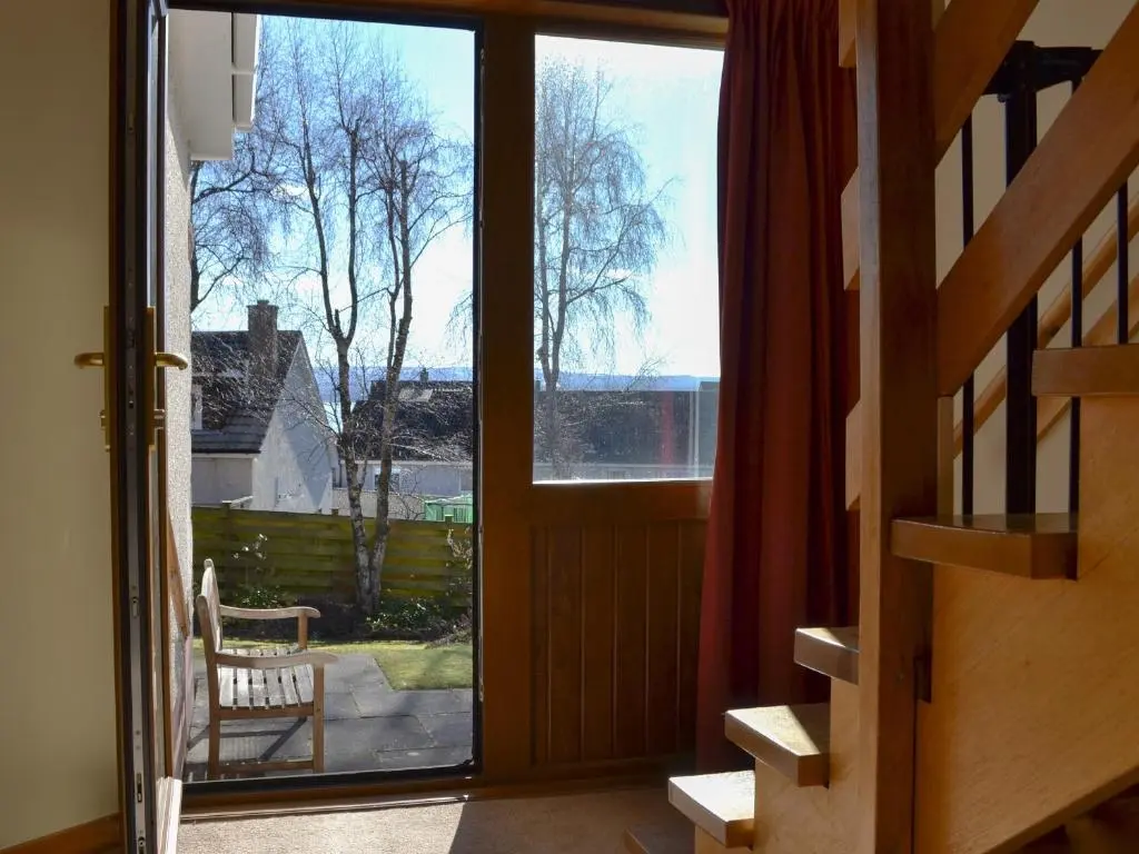 an open door with a view of a yard at Wester Links in Fortrose