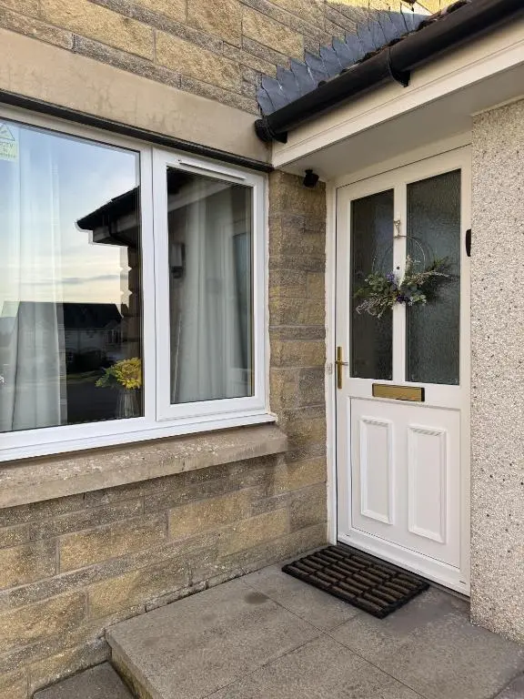 a house with a white door and windows at No 25 Inverness - Home from Home in the Highlands in Inverness