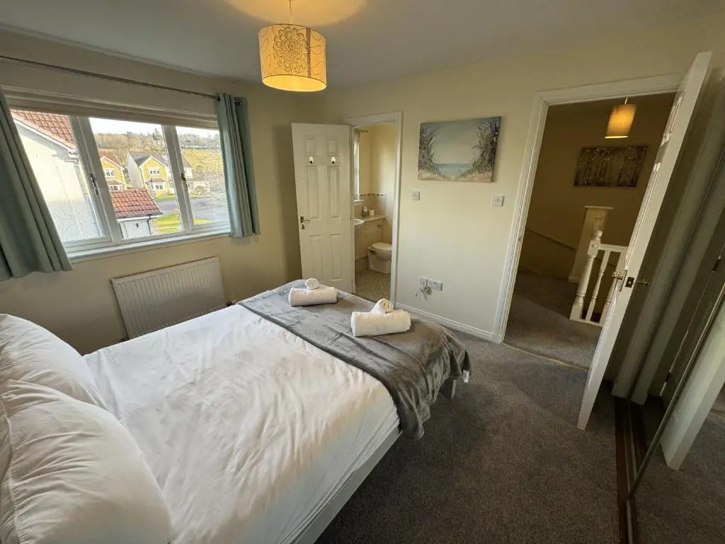 a bedroom with a bed with two towels on it at No 25 Inverness - Home from Home in the Highlands in Inverness