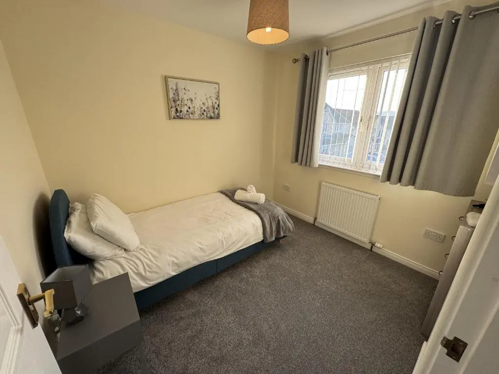 a small bedroom with a bed and a window at No 25 Inverness - Home from Home in the Highlands in Inverness