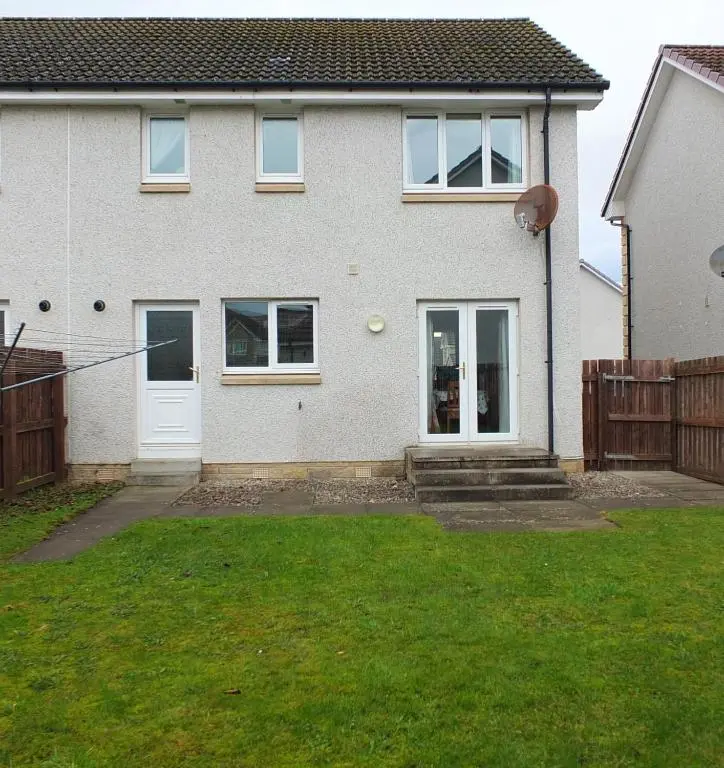 a white house with a fence and a yard at No 25 Inverness - Home from Home in the Highlands in Inverness