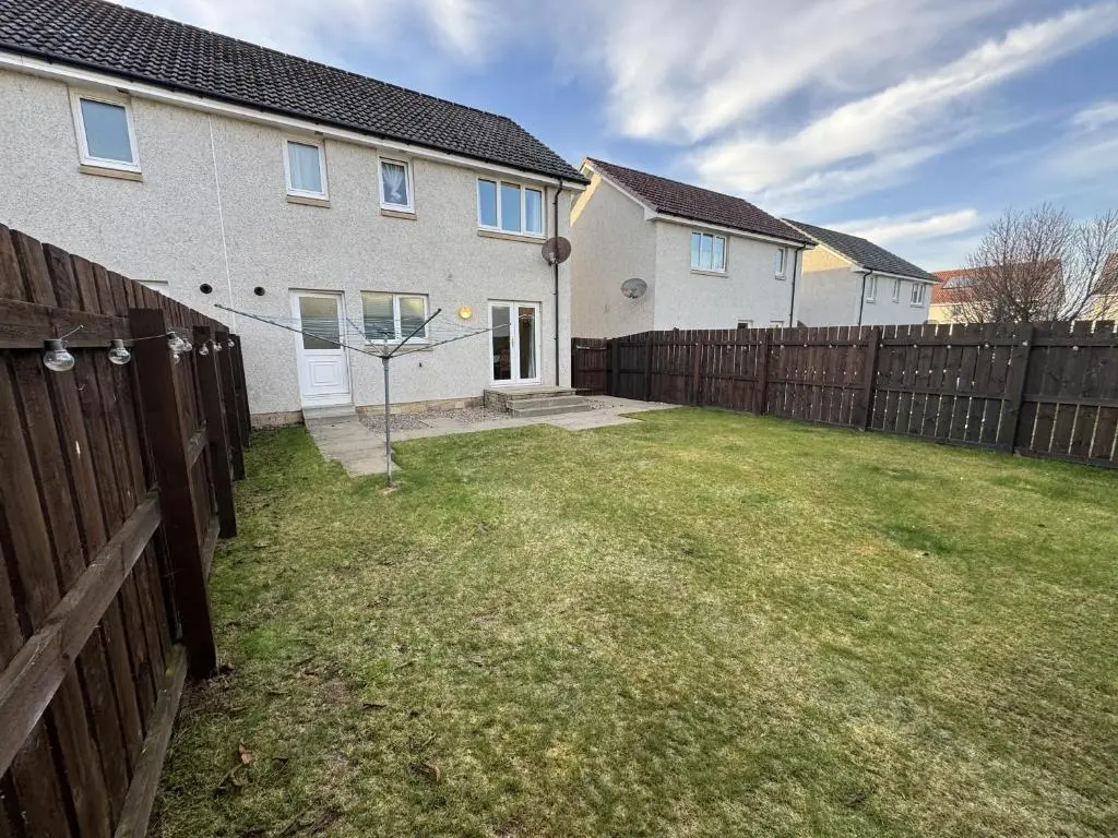a backyard with a fence and a basketball hoop at No 25 Inverness - Home from Home in the Highlands in Inverness
