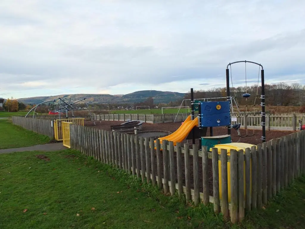 a playground in a park with a fence at No 25 Inverness - Home from Home in the Highlands in Inverness