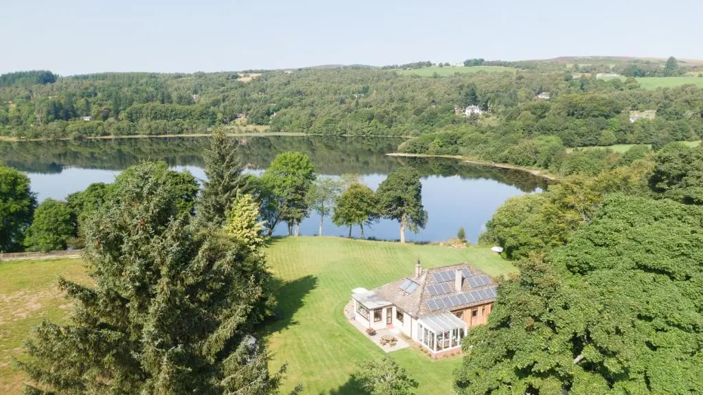 an aerial view of a mansion on a lake at Kinloch Lodge in Bearnock