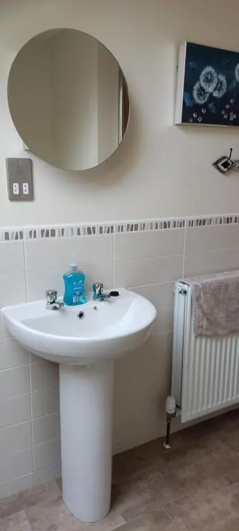 a bathroom with a white sink and a mirror at Rooms at The Cooperage in Auchleven