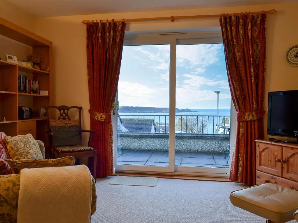 a living room with a large sliding glass door at Brae Lodge in Cullen