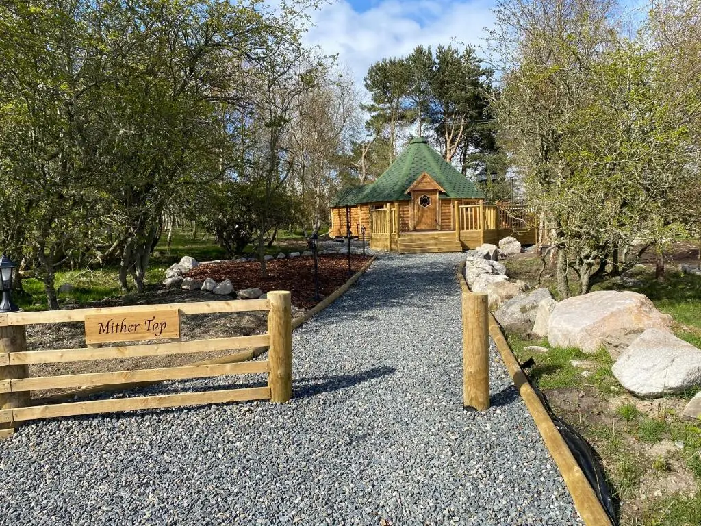 a wooden fence in front of a building at Woodland Lodge Mither Tap in Kintore