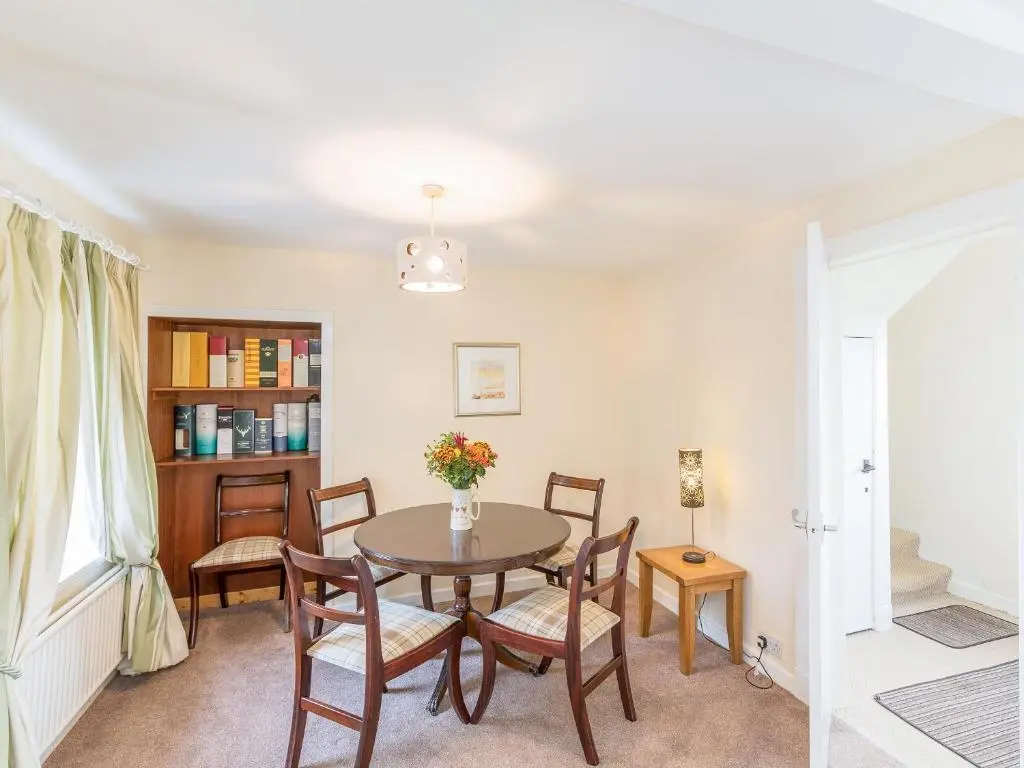 a dining room with a table and chairs at Balnain 1 in Cononbridge