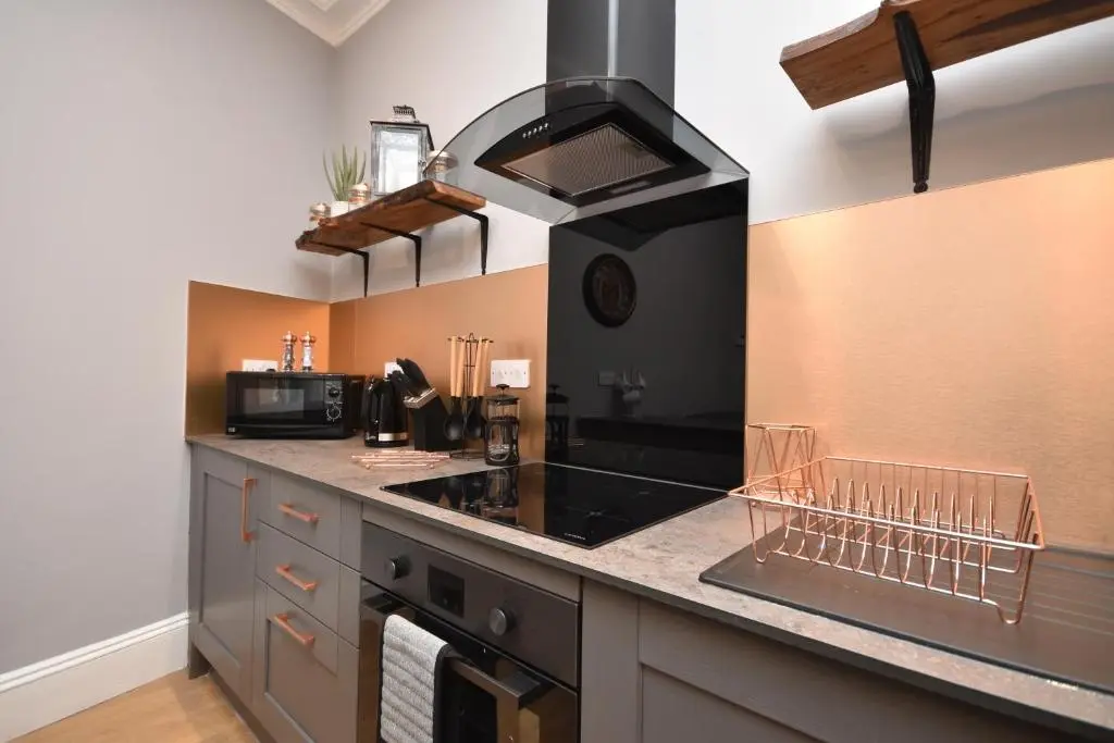 a kitchen with a stove and a counter top at Signature Apartments in Fraserburgh