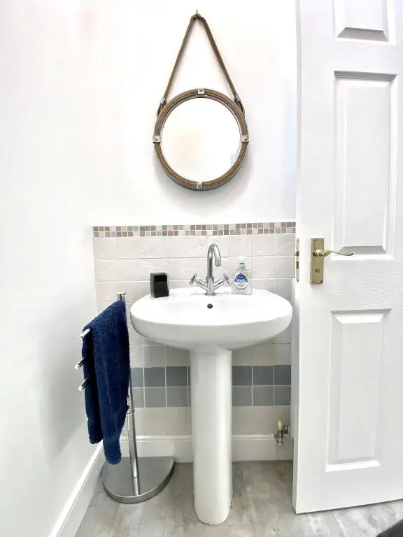 a bathroom with a sink and a mirror on the wall at Serviced Accommodation Moray - Lesmurdie House in Elgin