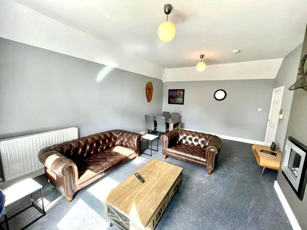 a living room with two leather couches and a coffee table at Serviced Accommodation Moray - Lesmurdie House in Elgin