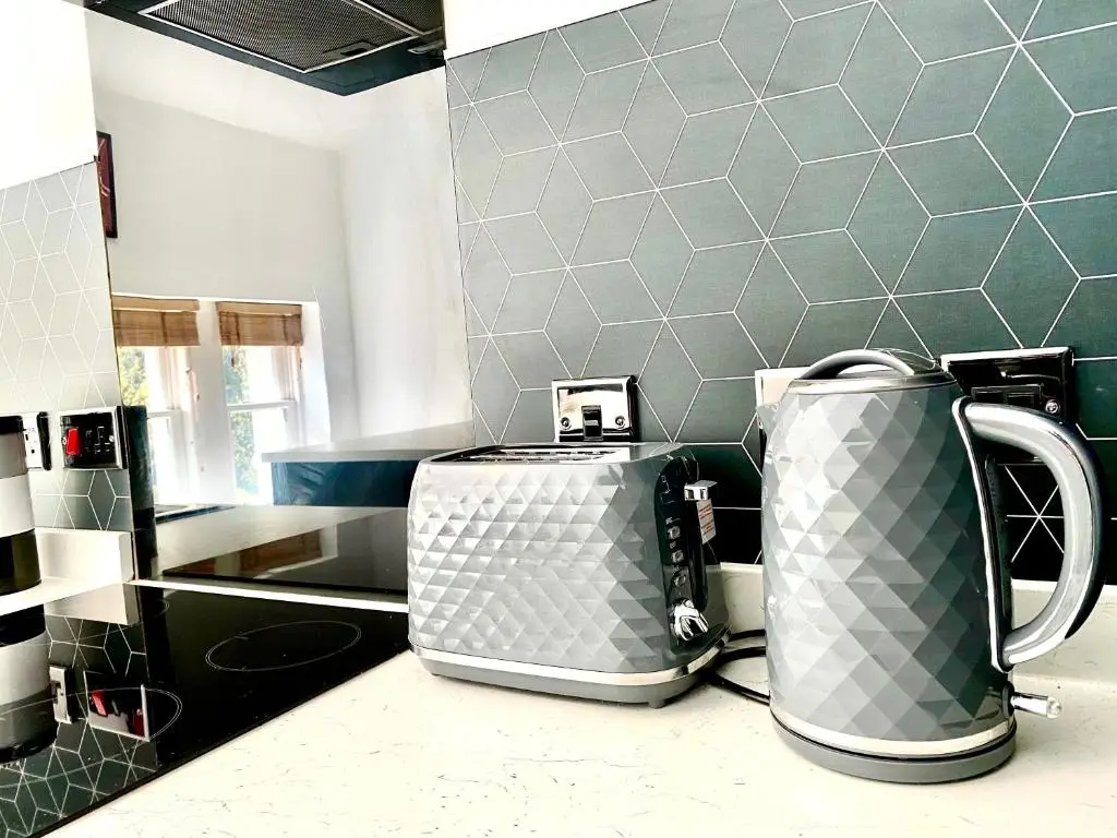 two coffeemakers sitting on a counter in a kitchen at Serviced Accommodation Moray - Lesmurdie House in Elgin