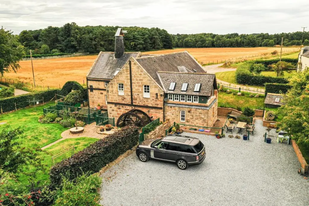 a car parked in front of a house at The Barley Mill in Elgin