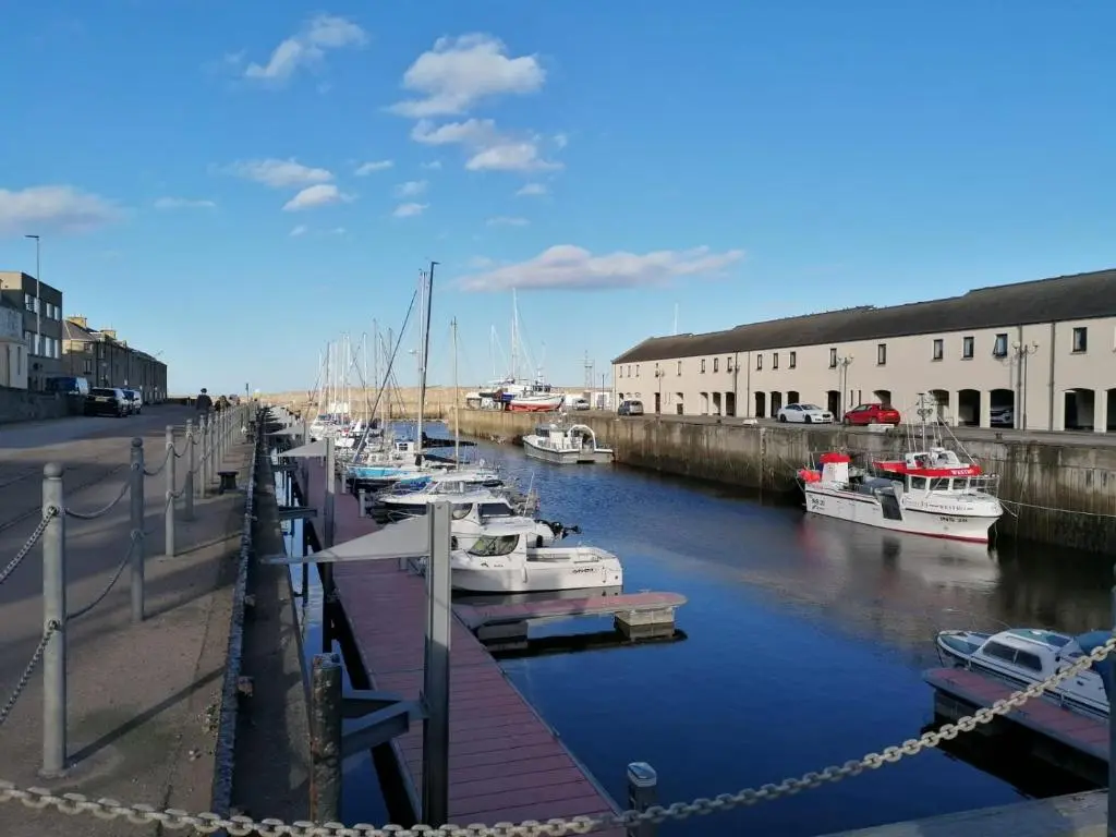 a bunch of boats are docked in a marina at 1 Fulmar Road**Next to West Beach and Golf Course in Lossiemouth