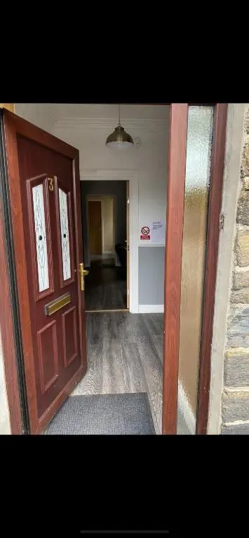 an open door to a room with a hallway at NC500, Wick Caithness Holiday Home in Wick