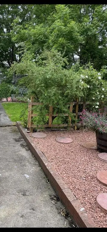a wooden fence in the middle of a garden at NC500, Wick Caithness Holiday Home in Wick