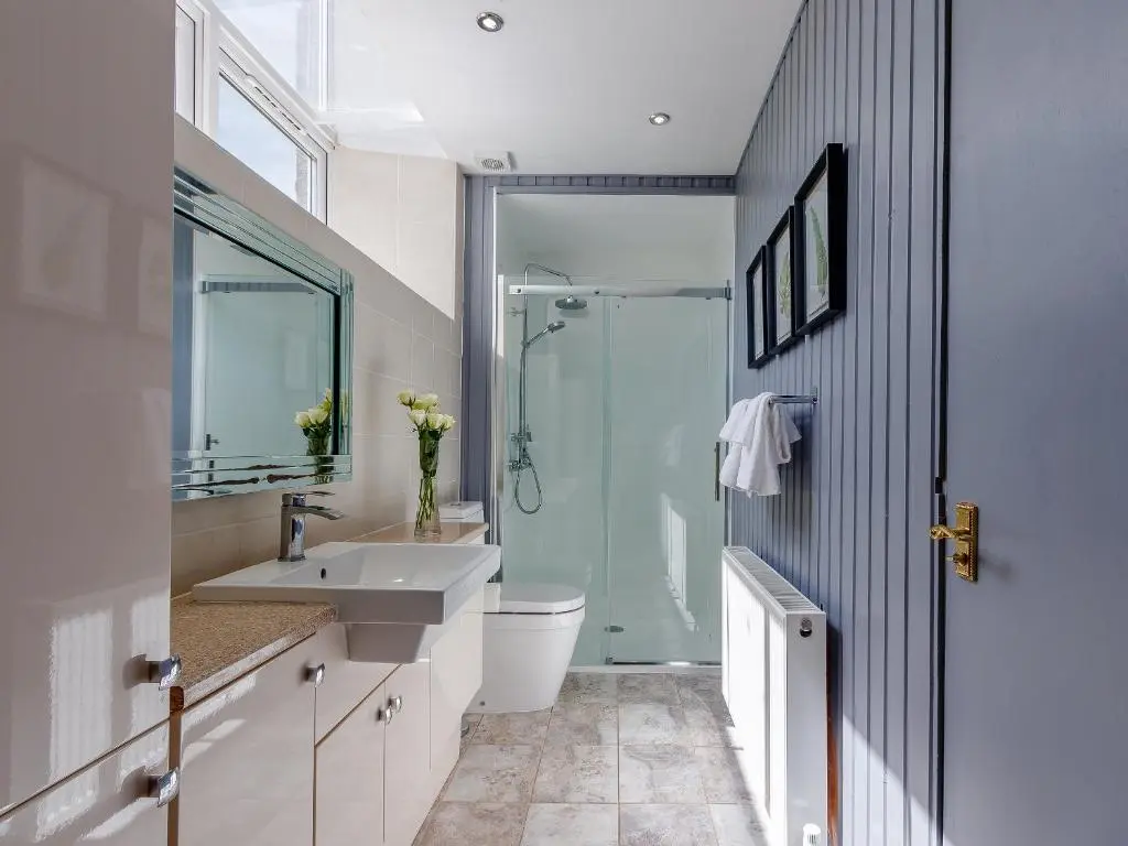 a bathroom with a shower and a sink and a toilet at Torreagles in Mintlaw