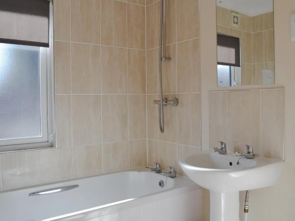 a bathroom with a sink and a bath tub and a sink at Lodge D- Uk33090 in Dinnet