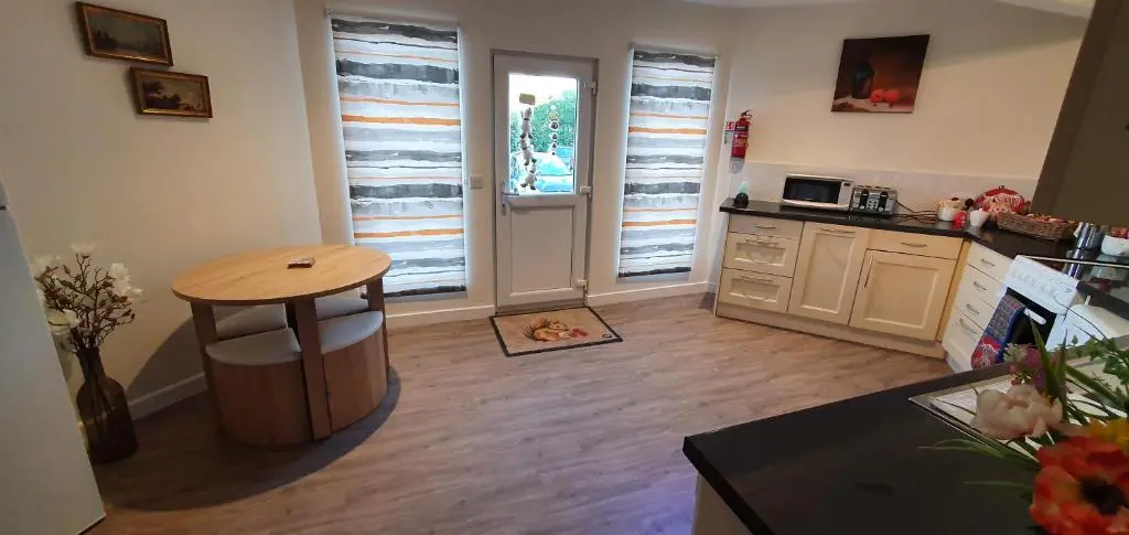 a kitchen with a wooden table and a table in a room at Meadows 2 in Auldearn