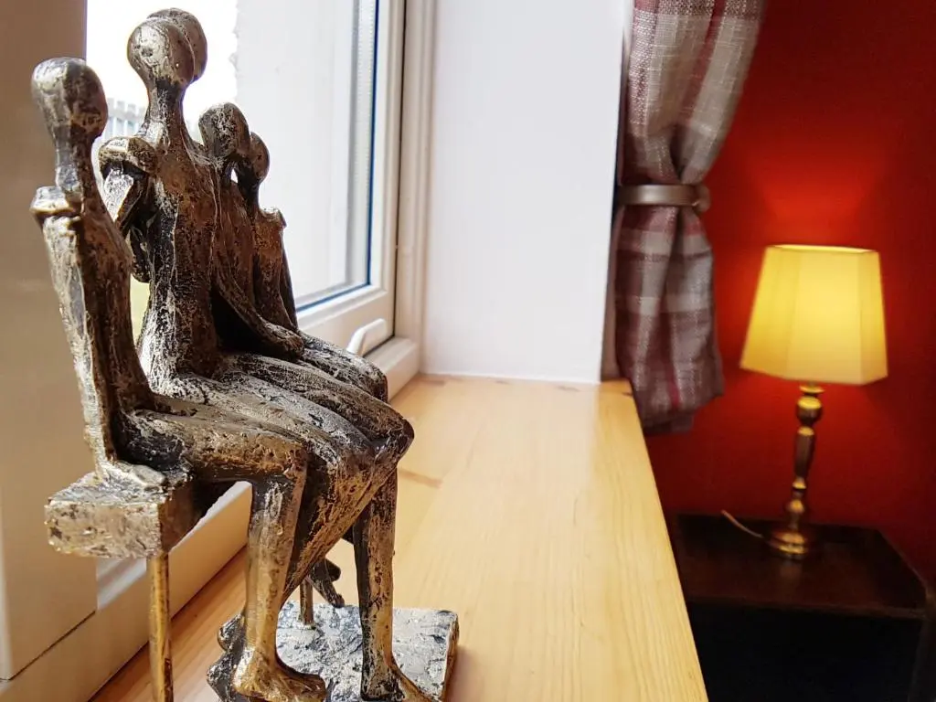 a wooden chair sitting on the floor next to a window at Hill View 2 bedroom free parking in Inverness