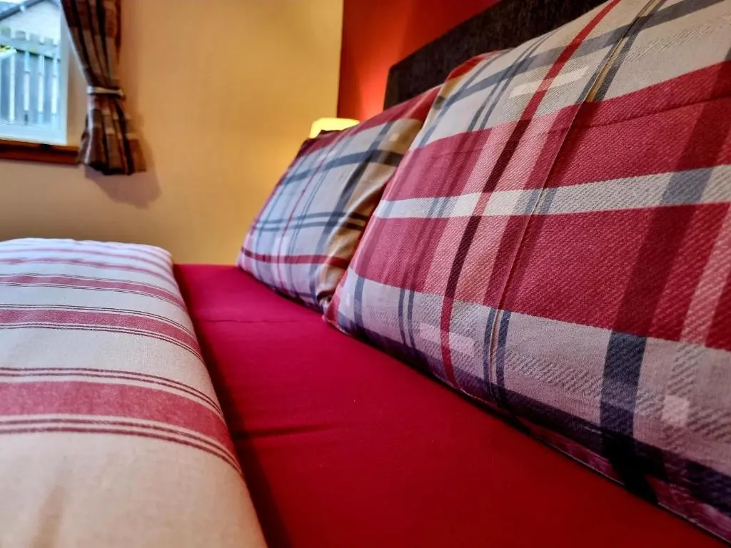 a couple of pillows sitting on top of a couch at Hill View 2 bedroom free parking in Inverness