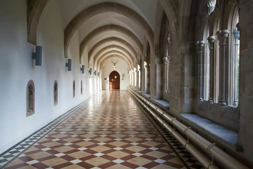 an aisle in a building with a checkered floor at The Ness Apartment Highland Club Scotland in Fort Augustus