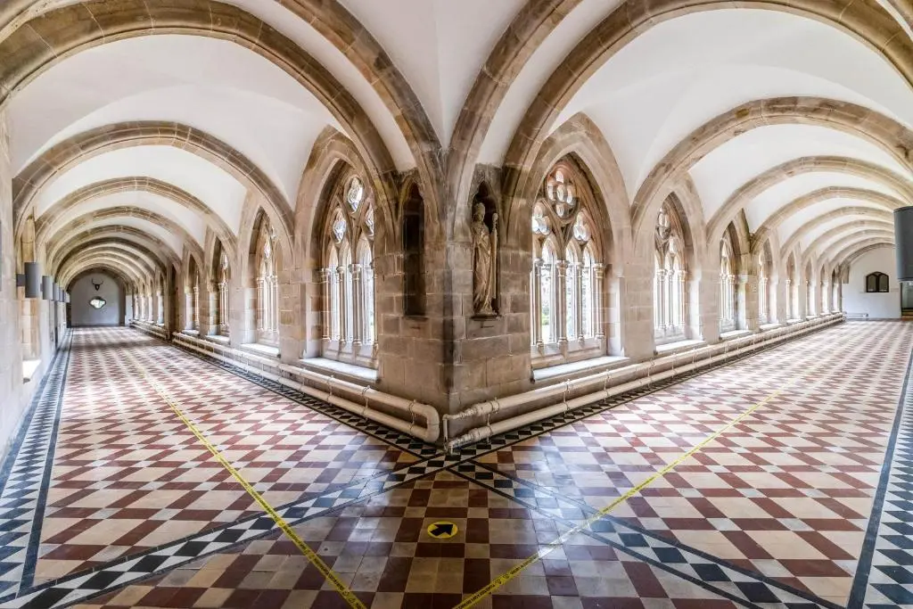 an empty hallway in a building with a checkered floor at The Ness Apartment Highland Club Scotland in Fort Augustus