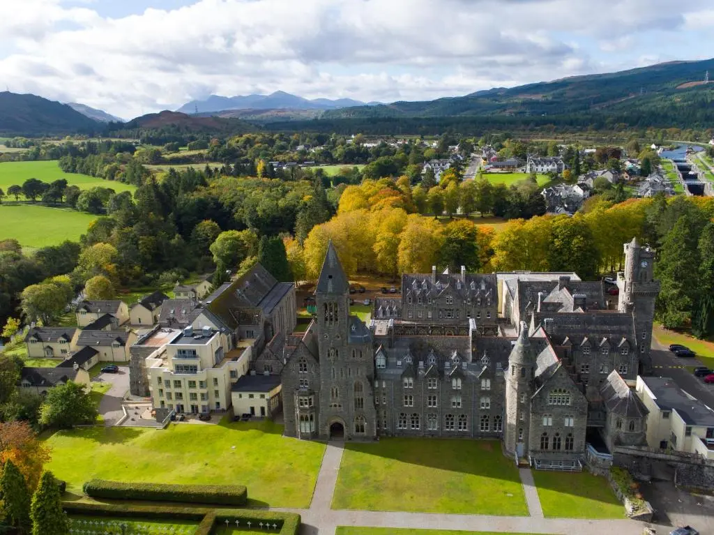 an aerial view of a castle in a city at The Ness Apartment Highland Club Scotland in Fort Augustus