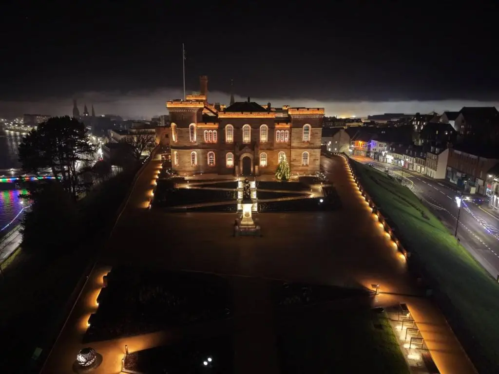 a building with lights in front of it at night at 2 Bed Self-Catering Lodge Inverness - Sleeps 4 in Inverness
