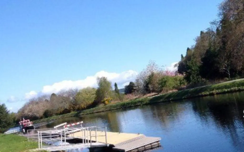 a boat is docked on the side of a river at 2 Bed Self-Catering Lodge Inverness - Sleeps 4 in Inverness