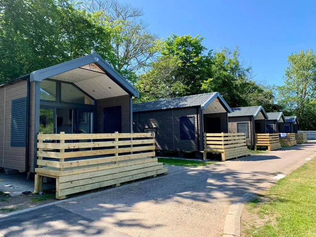 a row of camping cottages parked next to a road at 2 Bed Lodge - Sleeps 4 - Parking - Wifi in Inverness