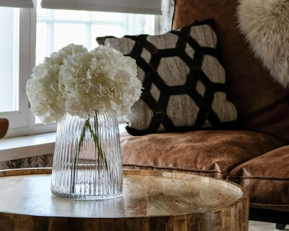a vase of white flowers sitting on a table at The Seafield Arms Hotel Cullen - Self Catering in Cullen