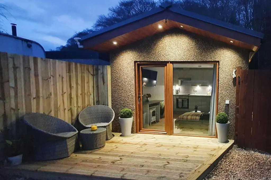a patio with two chairs and a sliding glass door at The Nook in Inverness