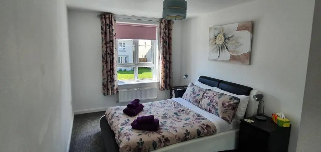a small bedroom with a bed and a window at Kellys in Inverness