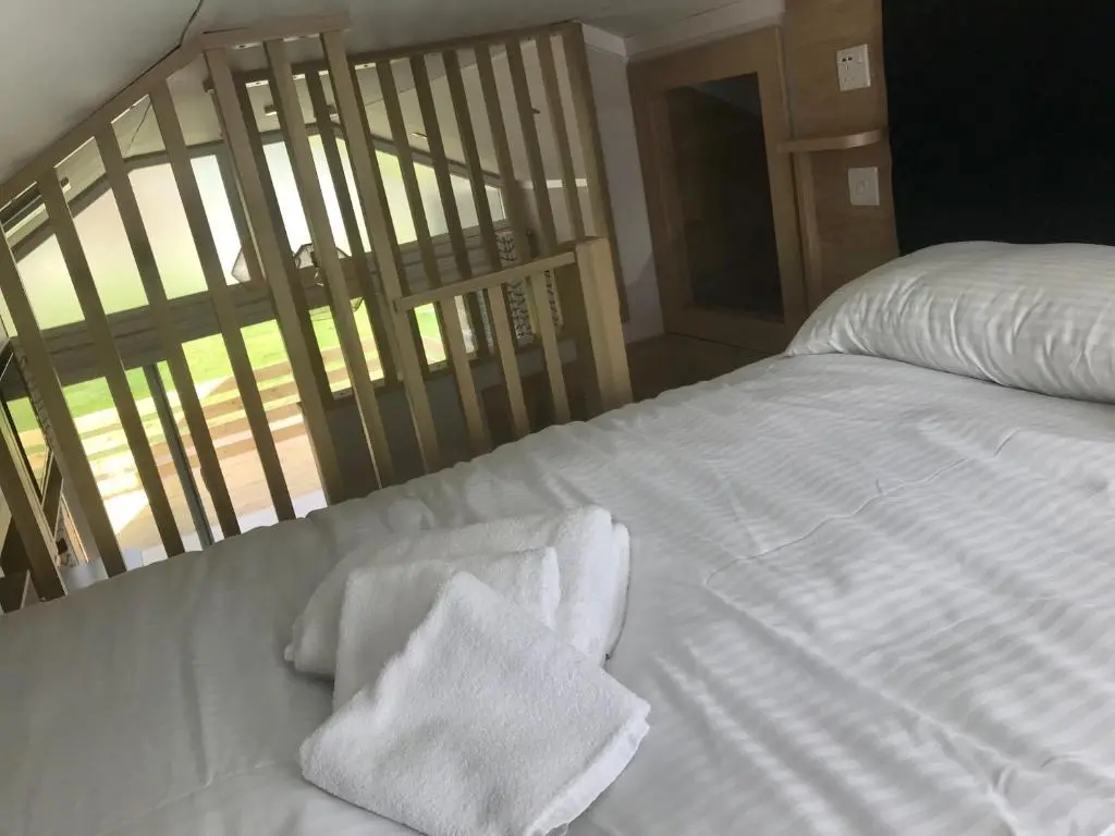 a white bed with white towels on top of it at Self-catering Lodge Inverness - Sleeps 4 in Inverness
