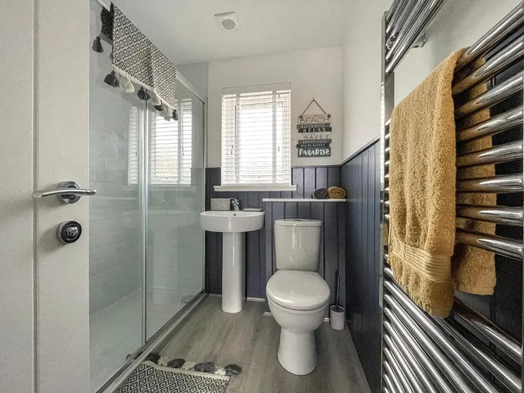 a bathroom with a toilet and a shower and a sink at Iseabail's House in Balintore