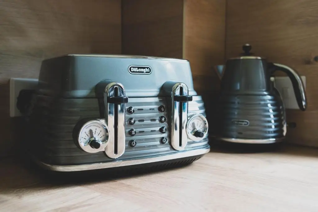 a toaster sitting on a counter next to a blender at The Nook Holiday Cottage in Aviemore
