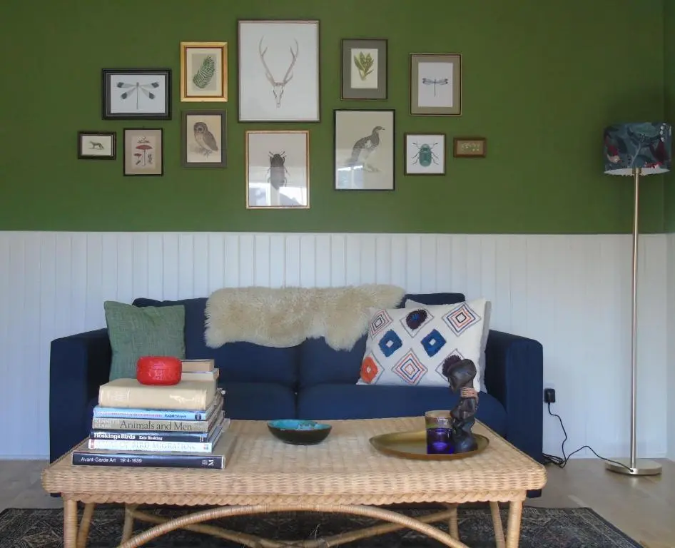 a living room with a blue couch and a table at Rowan Cottage, CrannachCottages in Garve