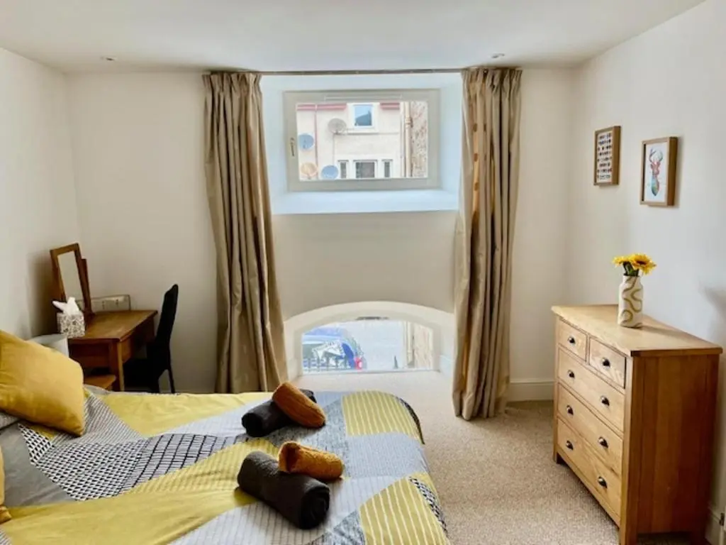 a bedroom with a bed and a window at Stunning spacious Apartment on River Ness in Inverness