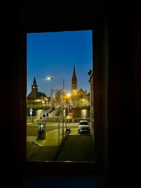 a view of a city from a window at Stunning spacious Apartment on River Ness in Inverness