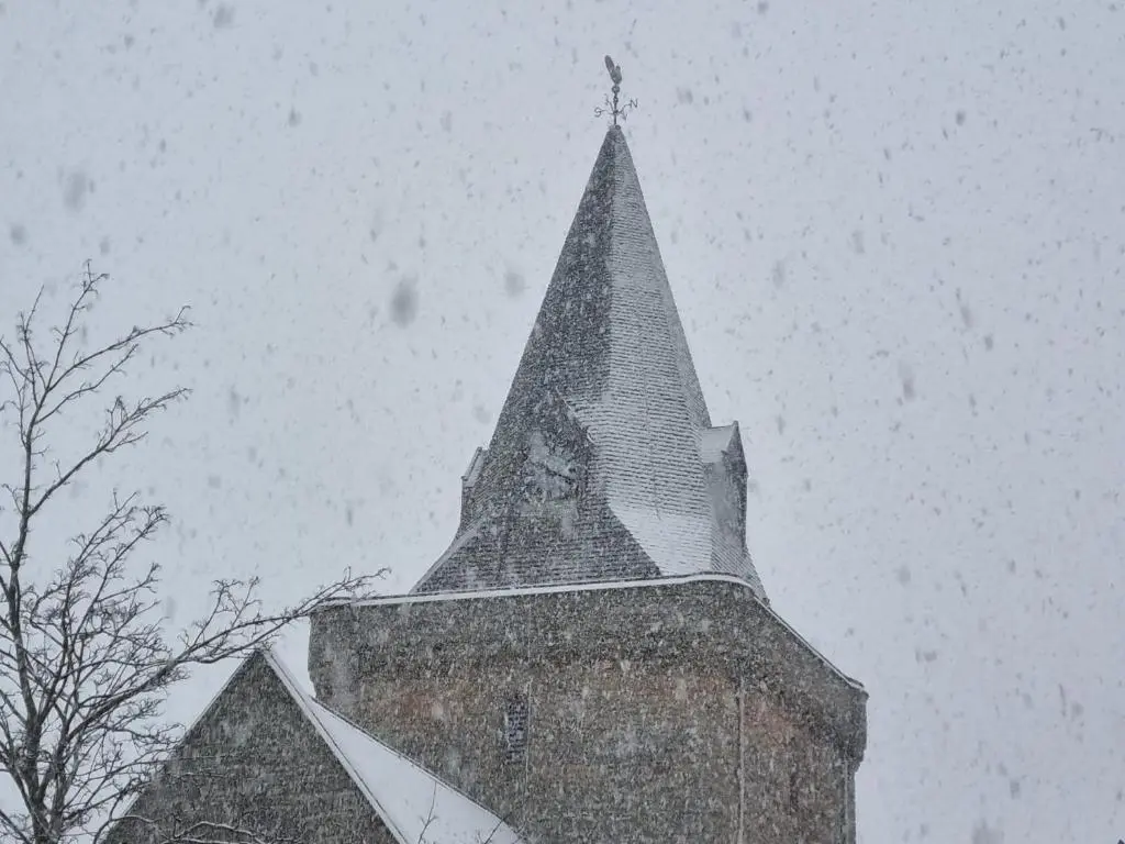 a steeple of a building with a clock on it at Balloan Cottage in Dornoch