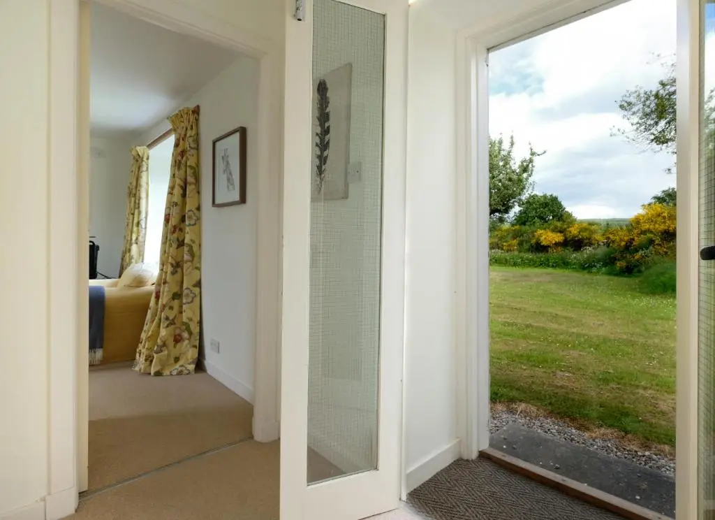 a door leading into a room with a window at Lower Bruntlands in Fochabers