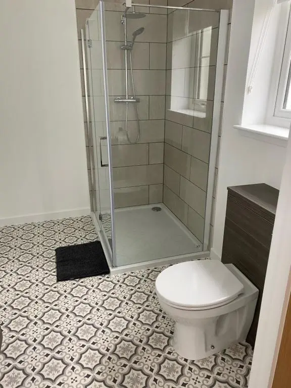 a bathroom with a shower and a toilet at Loch Ness House Blairbeg in Drumnadrochit