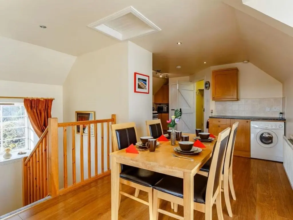 a kitchen and dining room with a table and chairs at Craiglea Lodge & Barn in Latheron