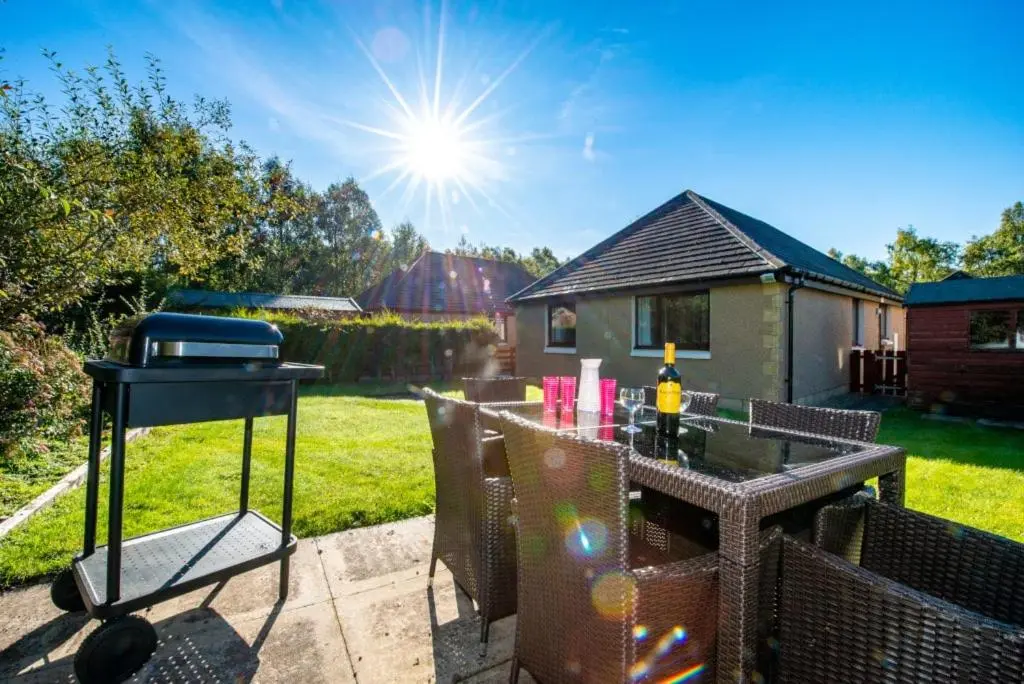 a bbq grill on a table in a backyard at Silverglades Holiday Homes in Aviemore