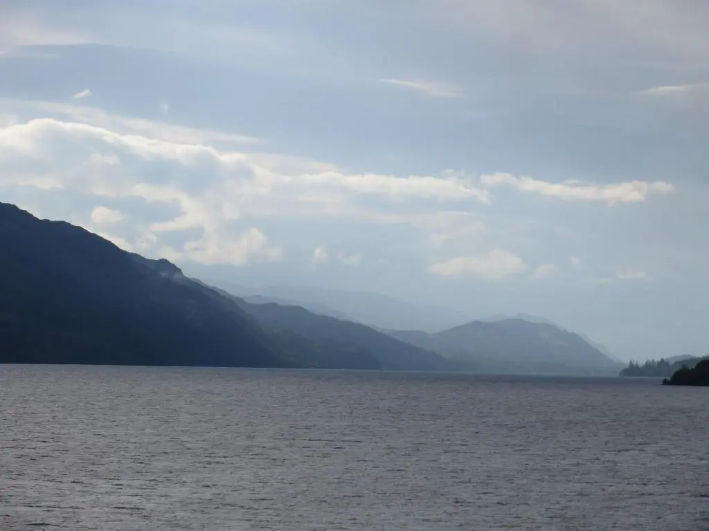 a large body of water with mountains in the background at Glenwood Apartment at The Highland Club in Fort Augustus
