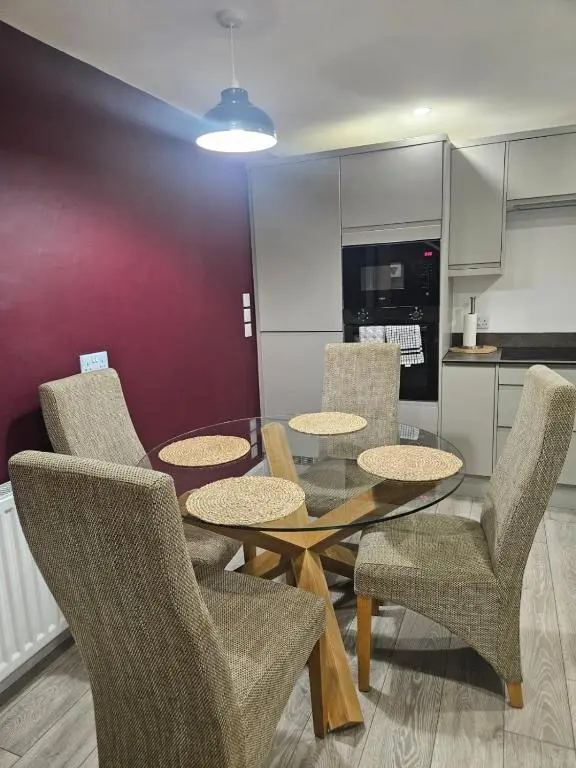 a dining room with a table and chairs at No 14, 3 BED all with SMART TV's, Fully Fitted Kitchen, Ample PARKING, Ideal for TRADES, BUSINESS wanting comfort and a quality service REDUCTIONS FOR LONGER STAYS Langley Cottages and Apartments, in Wick